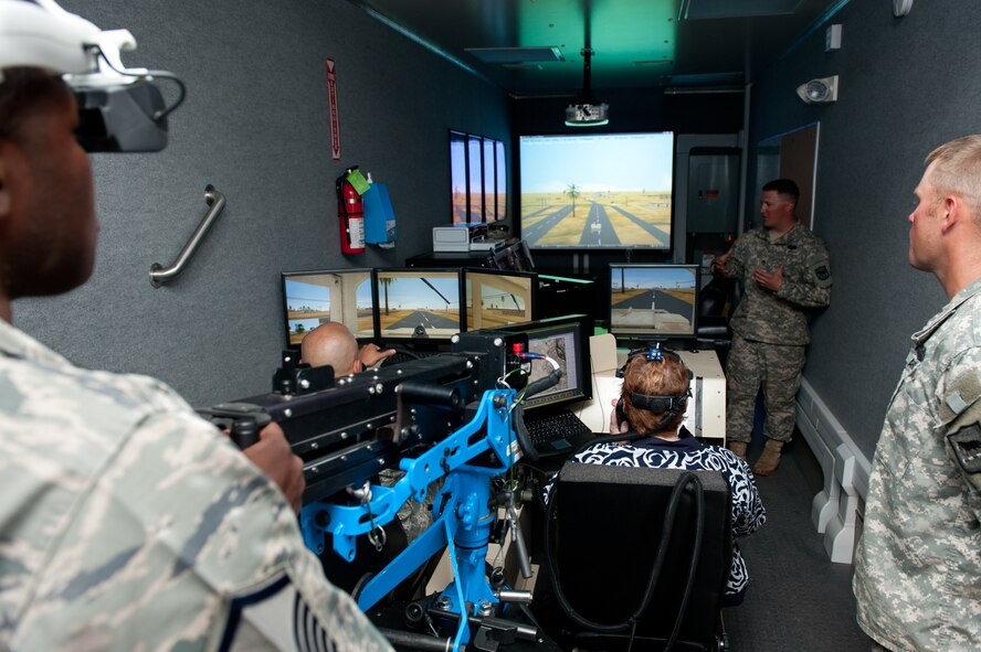 South Dakota Army National Guard instructors teach 28th Bomb Wing personnel how to operate a virtual convoy simulator during the Golden Coyote exercise at Camp Rapid, S.D., June 18, 2013. Training personnel on the simulator is one of the many aspects of the annual joint training exercise in which units perform a vast array of tasks and drills designed to provide training on their equipment, employ tactics, and complete various engineer projects that help improve the forest and infrastructure of the local communities. (U.S. Air Force photo by Senior Airman Kate Maurer/Released)