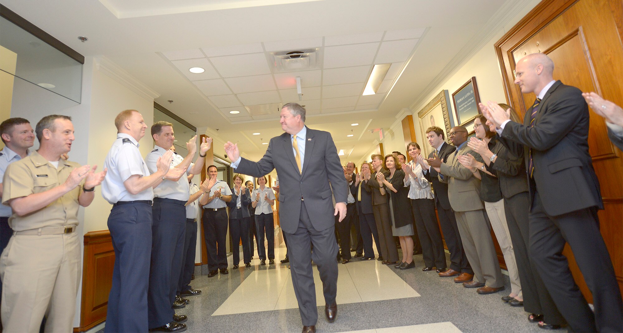 Secretary of the Air Force Michael Donley bids farewell to Airmen while departing from the Pentagon June 20, 2013, for the final time as the Air Force secretary. Donley was confirmed as the 22nd secretary of the Air Force Oct. 2, 2008. He served as the acting secretary since June of that year, as well as for seven months in 1993, making him the longest serving secretary in the history of the Air Force. His departure ceremony is June. 21, 2013. (U.S. Air Force photo/Michael J. Pausic)