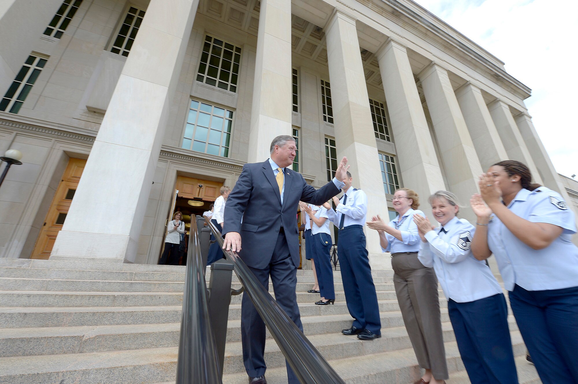 Secretary of the Air Force Michael Donley bids farewell to Airmen while departing from the Pentagon June 20, 2013, for the final time as the Air Force secretary. Donley was confirmed as the 22nd secretary of the Air Force Oct. 2, 2008. He served as the acting secretary since June of that year, as well as for seven months in 1993, making him the longest serving secretary in the history of the Air Force. His departure ceremony is June. 21, 2013. (U.S. Air Force photo/Michael J. Pausic)
