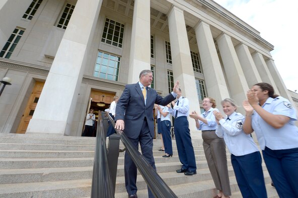 Secretary of the Air Force Michael Donley bids farewell to Airmen while departing from the Pentagon June 20, 2013, for the final time as the Air Force secretary. Donley was confirmed as the 22nd secretary of the Air Force Oct. 2, 2008. He served as the acting secretary since June of that year, as well as for seven months in 1993, making him the longest serving secretary in the history of the Air Force. His departure ceremony is June. 21, 2013. (U.S. Air Force photo/Michael J. Pausic)