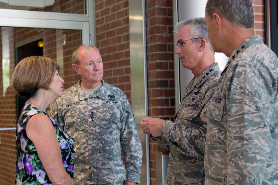 Air Force Gen. Paul J. Selva, commander of Air Mobility Command, talks with Army Gen. Martin E. Dempsey, chairman of the Joint Chiefs of Staff, second from left, Dempsey's wife, Deanie, and Air Force Gen. William M. Fraser III, commander of U.S. Transportation Command, on Scott Air Force Base, Ill., June 19, 2013. (DOD photo/D. Myles Cullen) 