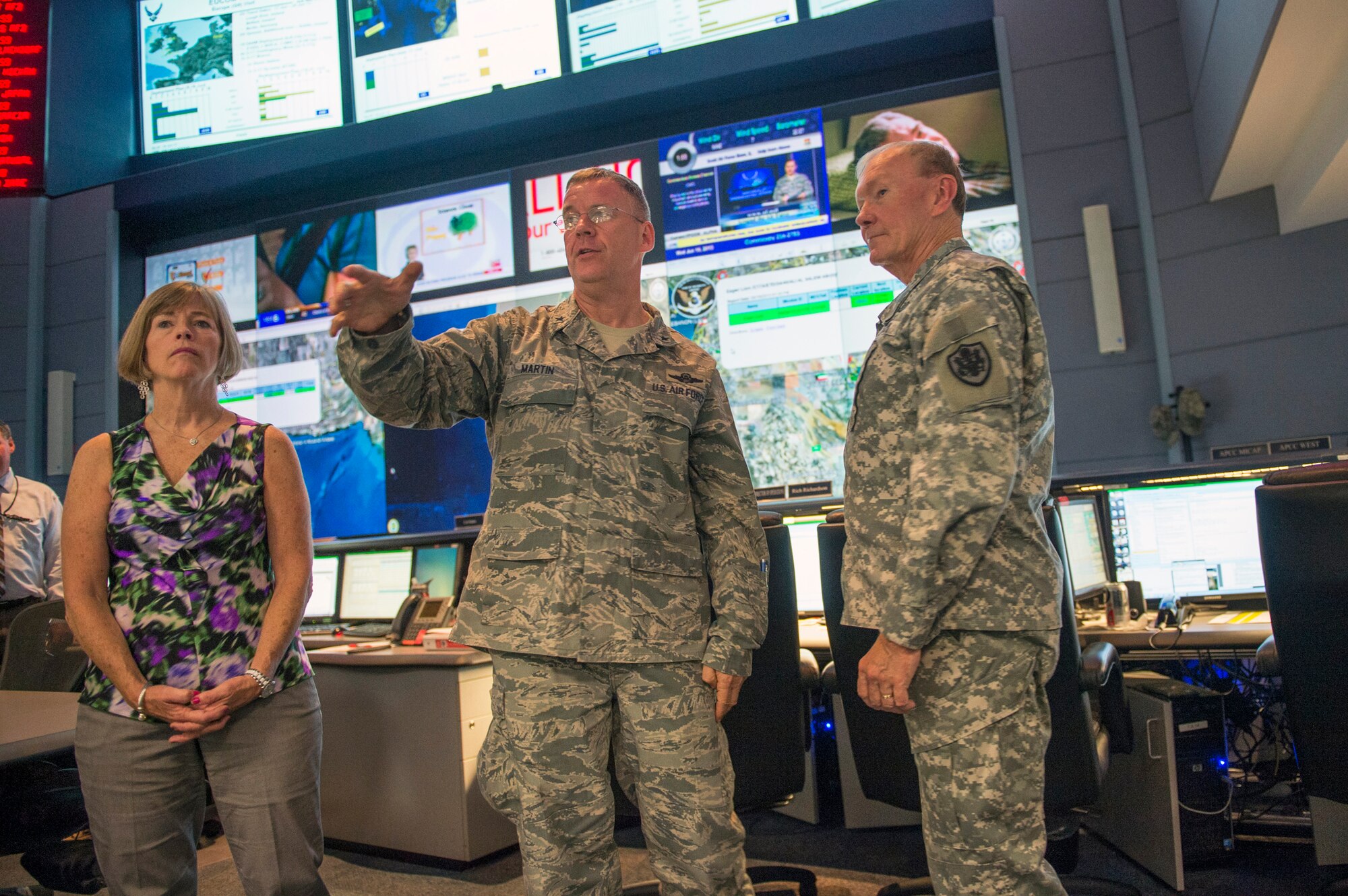 Army Gen. Martin E. Dempsey, right, chairman of the Joint Chiefs of Staff, and his wife, Deanie, receive a tour from Air Force Brig. Gen. Lawrence M. Martin Jr., vice commander of the 618th Air and Space Operations Center, on Scott Air Force Base, Ill., Jun 19, 2013. (DOD photo/D. Myles Cullen) 