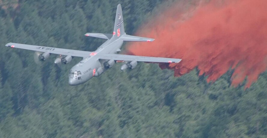 A Modular Airborne Fire Fighting System-equipped C-130 from the Air Force Reserve Command’s 302nd Airlift Wing drops a load of a retardant on the Lime Gulch fire June 19 in southern Jefferson County, Colo. The 2013 MAFFS fire season began a week earlier when aircrews battled the Black Forest fire near Colorado Springs, Colo. (Courtesy photo)