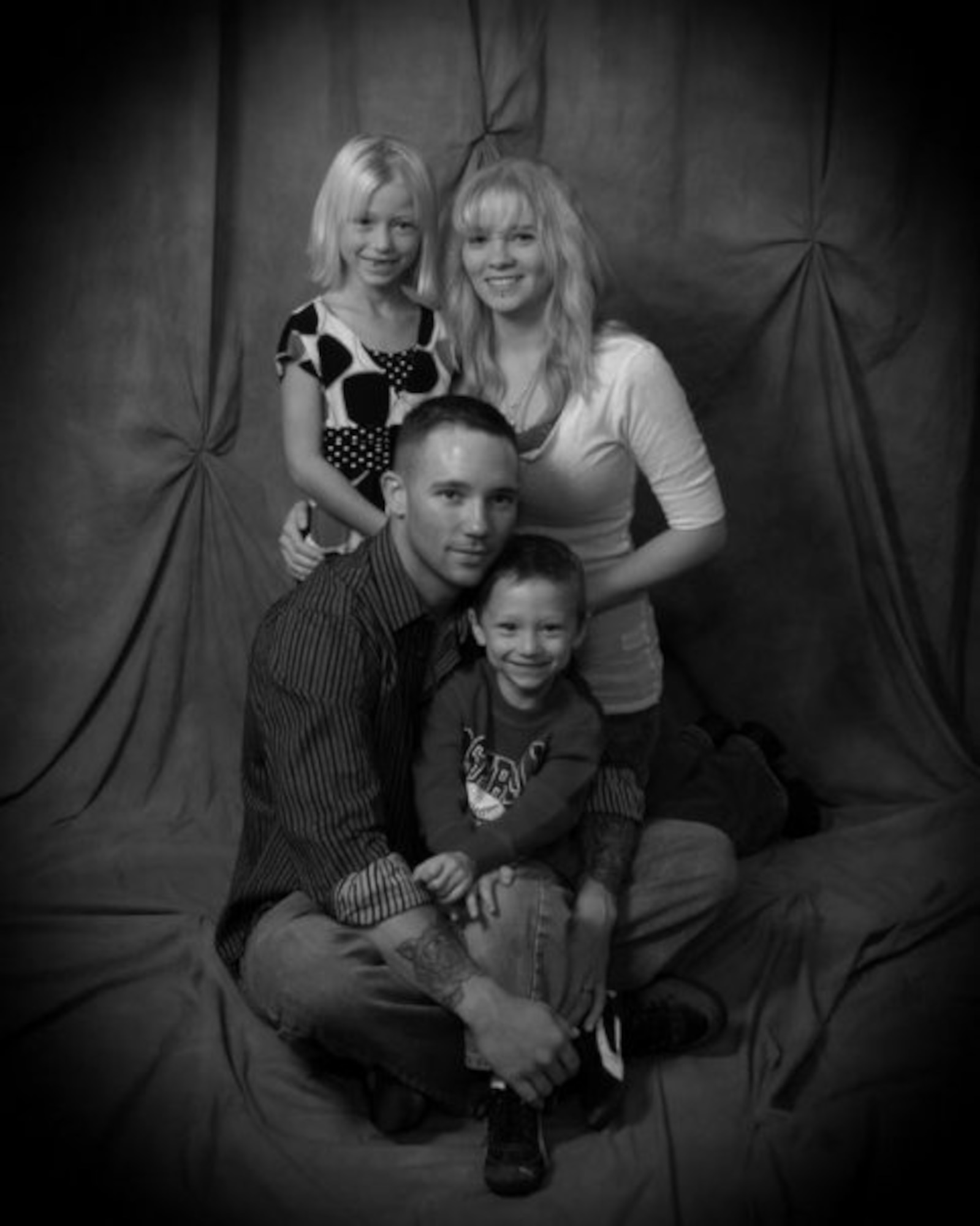 Brianna Pate, U.S. Air Force Staff Sgt. Kimberly Pate, 4th Civil Engineer explosive ordnance disposal NCO-in charge of operations, U.S. Marine Corps Gunnery Sgt. EJ Pate, former EOD technician, and Ashton Pate, pose for a family photo. Pate was recently named North Carolina Servicewoman of the Year by the American Legion Auxiliary Past Presidents Parley in Raleigh, N.C. Her husband was killed in action. (Courtesy photo)
