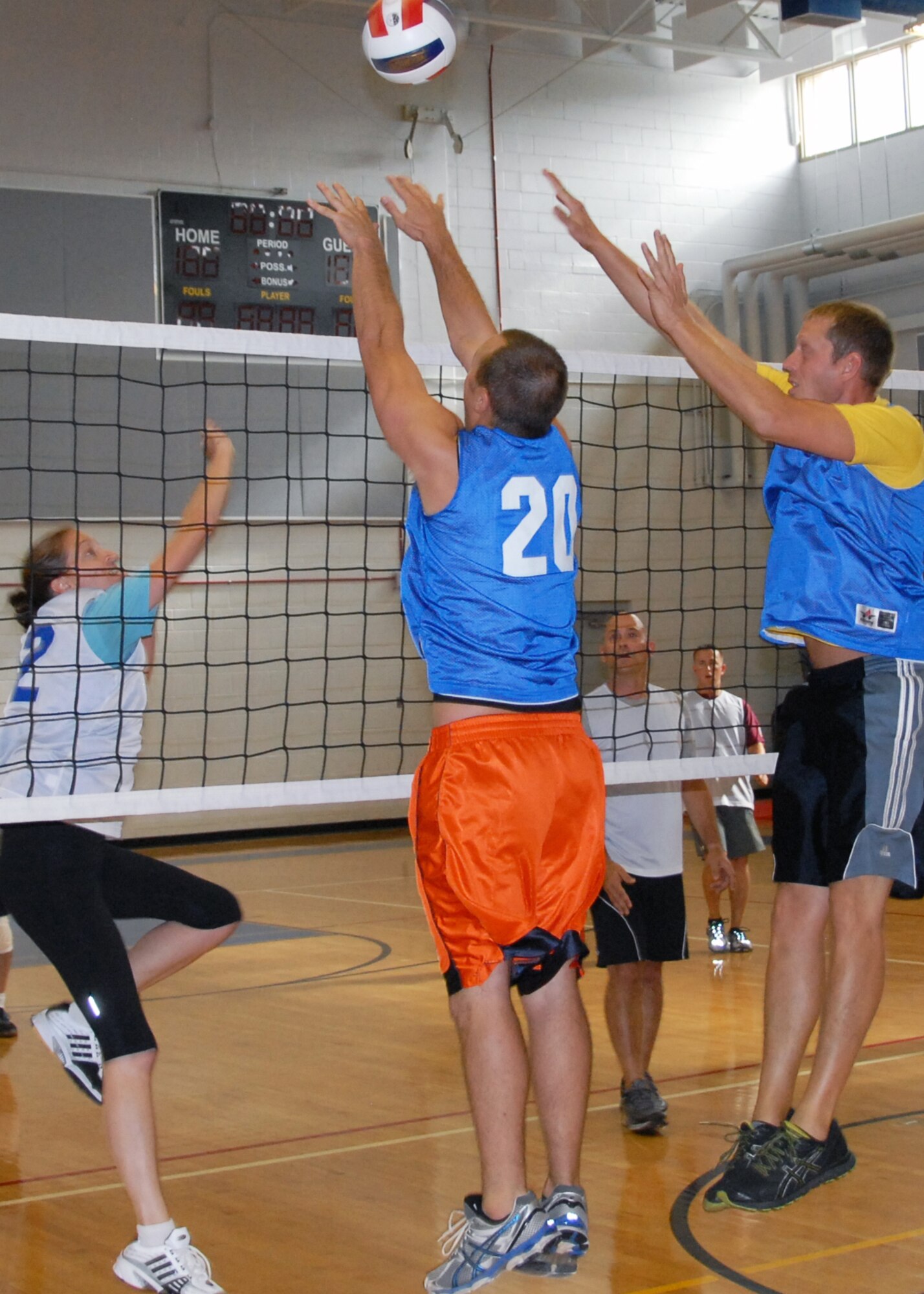 Dirk Haller, middle, and Stephen Jackson, members of the 96th Operations Group’s volleyball team, block a shot from Emily Curtis, a member of the 53rd Wing’s volleyball team, during the intramural volleyball championship game at Eglin Air Force Base, Fla. June 19.  The 96 OG won the fifth game of the best three-out-five contest, 15-8, to claim the championship title.  (U.S. Air Force photo/Kevin Gaddie)