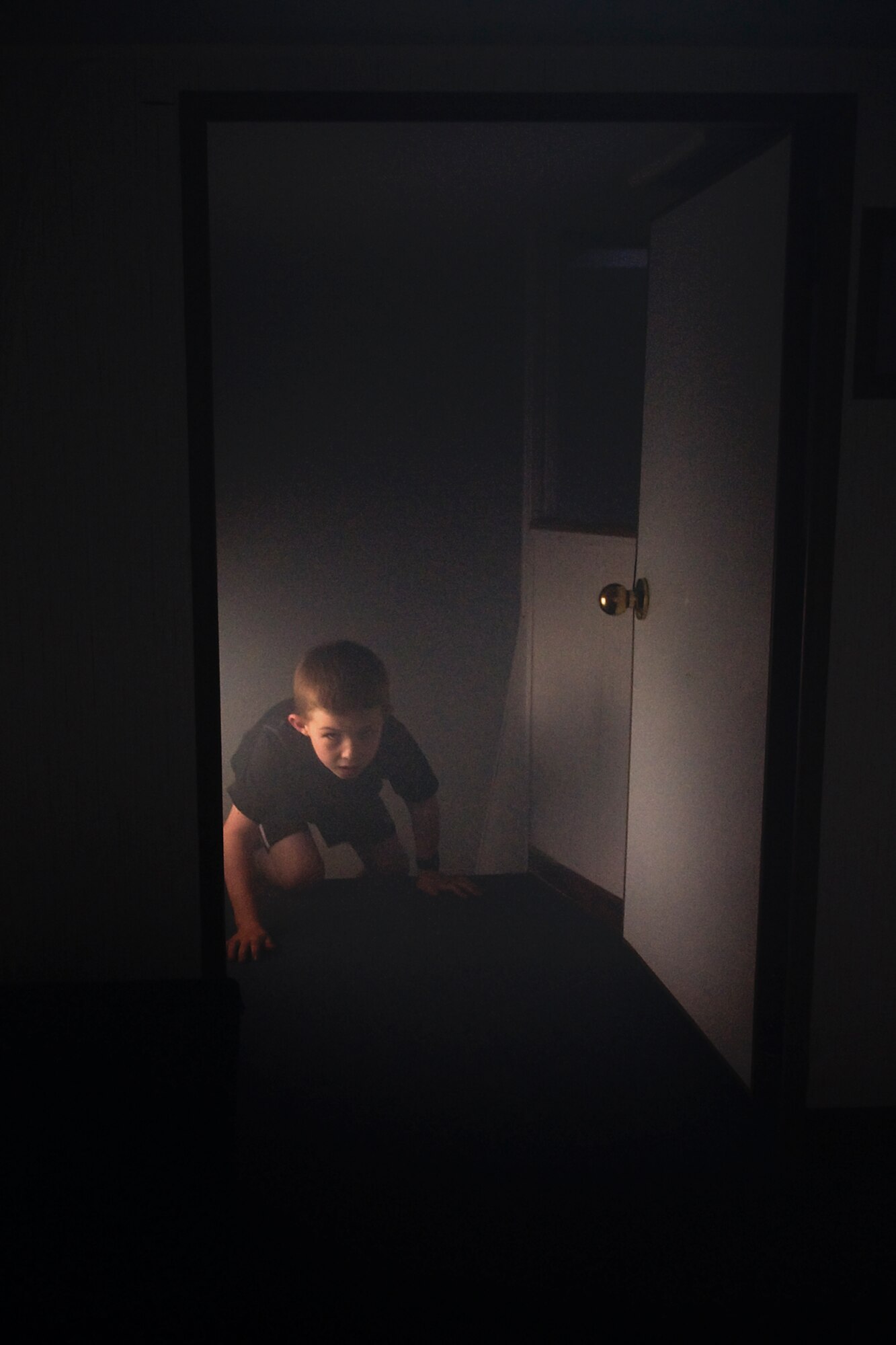 A young child crawls through a simulated smokey house during Grissom's annual Family Appreciation Day picnic held here June 1, 2013. The Grissom Fire Department uses a smoke house is to teach children and families what to do during a fire and how to properly evacuate. (U.S. Air Force photo/Senior Airman Jami K. Lancette)