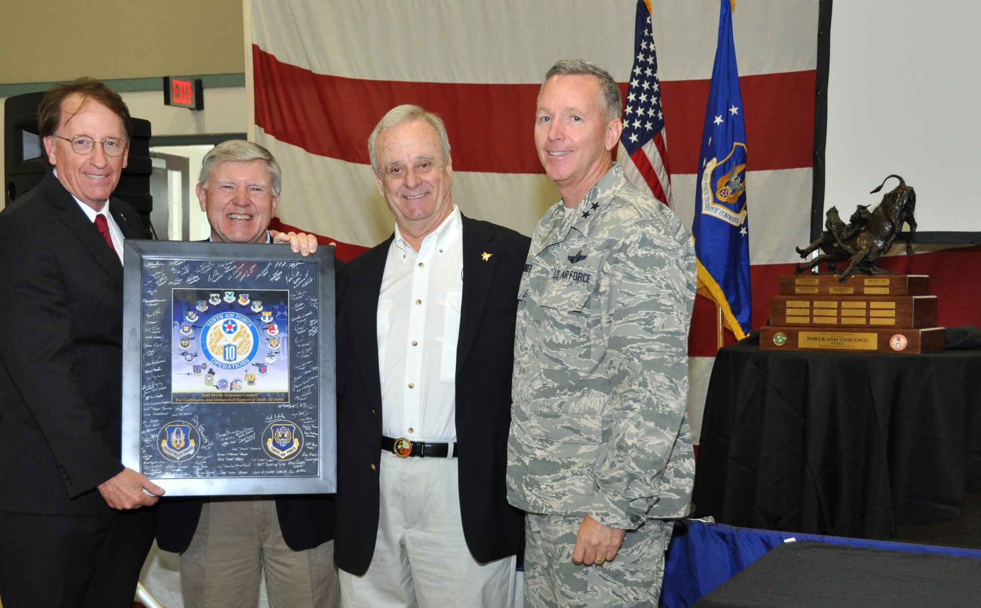 Sid Epps, Air Power Council Chairman, accepts a token of gratitude from Maj. Gen. Bill Binger, 10th Air Force commander, for the APC’s continued support to the men and women of 10th Air Force.  From left to right, Roger Latham, John Kinnear and Sid Epps, all APC members and Maj. Gen. Bill Binger, 10th AF commander, were at the base for this year’s presentation of The Power and Vigilance Award. This award is presented annually to the Tenth Air Force Air Force Reserve unit that exhibits the NAF mission as "the premier provider of affordable, integrated, flexible, and mission-ready Citizen Airmen to execute power and vigilance missions in support of U.S. National Security. The symbolism of the bronze figure on the award says it all, "grabbing the bull by the horns". This year's winner of 10th Air Force's Power and Vigilance trophy is the 442nd Fighter Wing at Whiteman Air Force Base, Missouri. This is only the four year this trophy has found a home, the first three winners being 477th Fighter Group, Elmendorf, Alaska, 482nd Fighter Wing, Homestead ARB, Fla., and the 301st Fighter Wing, NAS Fort Worth JRB. (U.S. Air Force photo/Master Sgt. Julie Briden-Garcia)