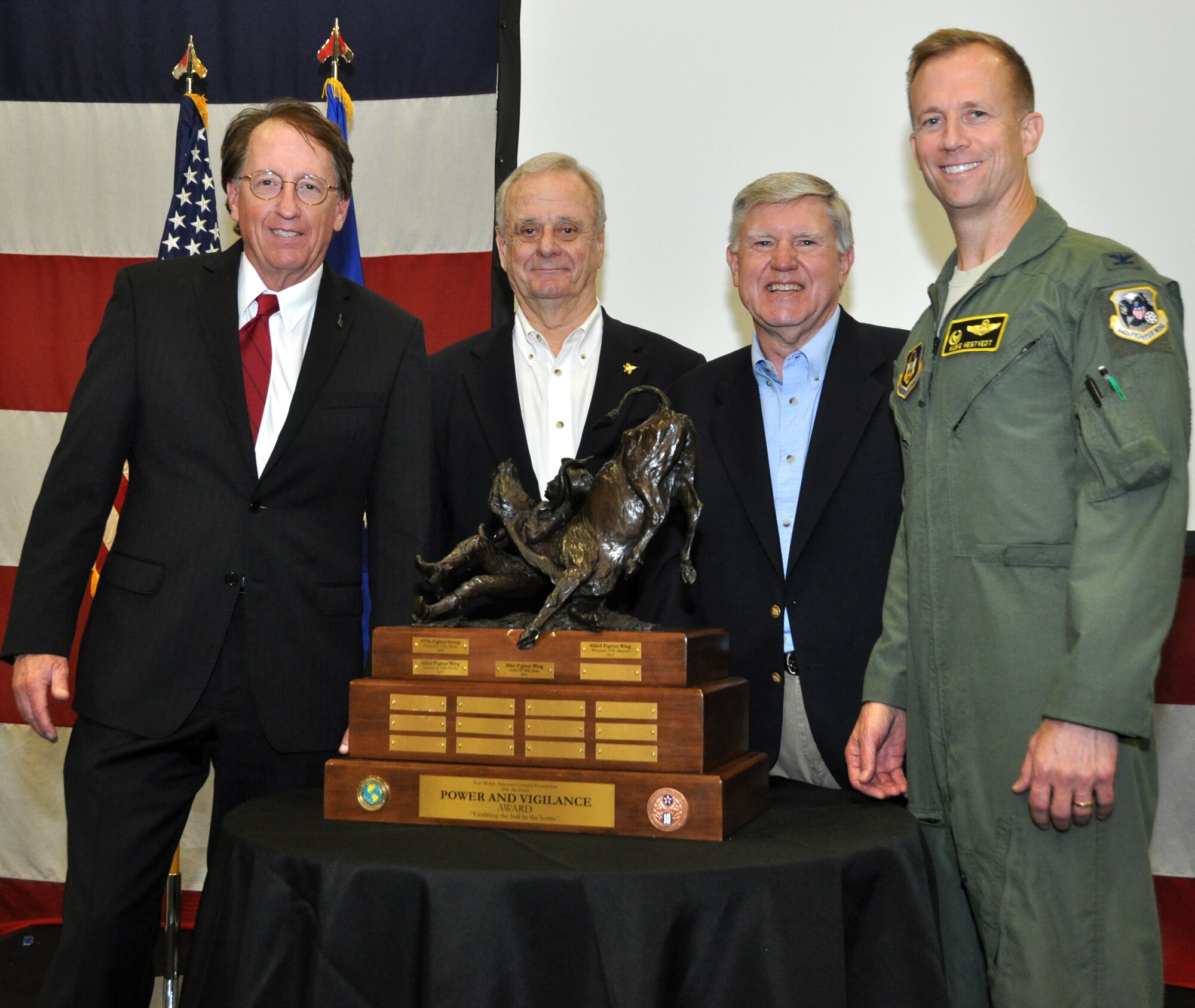 This year's winner of 10th Air Force's Power and Vigilance trophy is the 442nd Fighter Wing at Whiteman Air Force Base, Missouri. From left to right, Roger Latham, John Kinnear and Sid Epps, all from the Fort Worth’s Air Power Council, and Col. Hubie Hegtvedt, 442nd Fighter Wing commander, were at the Naval Air Station Fort Worth Joint Reserve Base, Texas, for this year’s presentation of The Power and Vigilance Award. This is only the four year this trophy has found a home, the first three winners being 477th Fighter Group, Elmendorf, Alaska, 482nd Fighter Wing, Homestead ARB, Fla., and the 301st Fighter Wing, NAS Fort Worth JRB. The Power and Vigilance Award is presented annually to the Tenth Air Force Air Force Reserve unit that exhibits the NAF mission as "the premier provider of affordable, integrated, flexible, and mission-ready Citizen Airmen to execute power and vigilance missions in support of U.S. National Security. The symbolism of the bronze figure on the award says it all, "grabbing the bull by the horns". (U.S. Air Force photo/Master Sgt. Julie Briden-Garcia)
