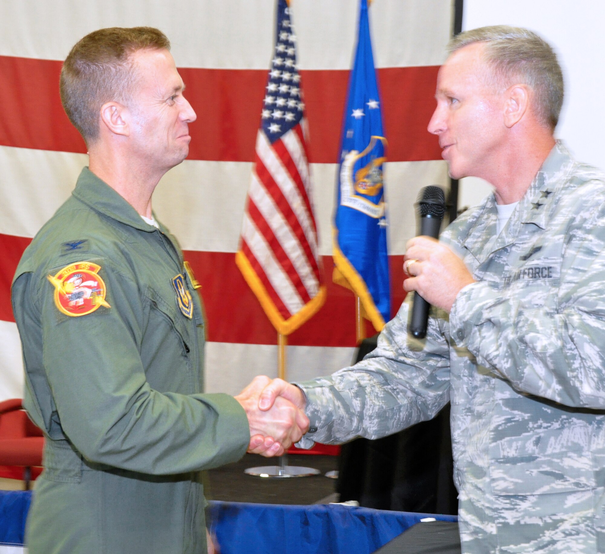 Maj. Gen. Bill Binger, 10th Air Force commander, congratulates this year's winner of the 10th Air Force Power and Vigilance trophy, Col. Hubie Hegtvedt, 442nd Fighter Wing commander. This is only the four year this trophy has found a home. The first three winners being 477th Fighter Group, Elmendorf, Alaska, 482nd Fighter Wing, Homestead ARB, Fla., and the 301st Fighter Wing, NAS Fort Worth JRB, Texas. The Power and Vigilance Award is presented annually to the Tenth Air Force Air Force Reserve unit that exhibits the NAF mission as "the premier provider of affordable, integrated, flexible, and mission-ready Citizen Airmen to execute power and vigilance missions in support of U.S. National Security. The symbolism of the bronze figure on the award says it all, "grabbing the bull by the horns". (U.S. Air Force photo/Master Sgt. Julie Briden-Garcia)
