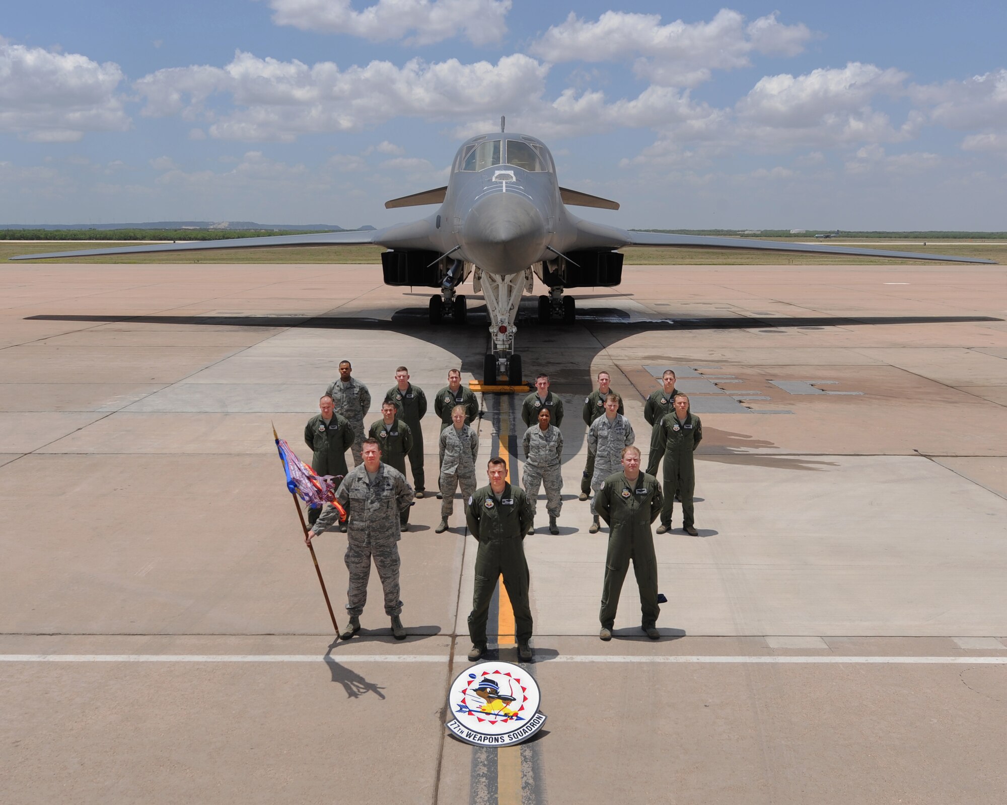 The 77th Weapons Squadron (WPS) poses for a squadron photo in front of a B-1 Bomber April 15, 2013, at Dyess Air Force Base, Texas. The 77th WPS is one of the oldest and most decorated bombardment squadrons in the U.S. Air Force. It provides weapons training to B-1 Bomber squadrons at Dyess AFB and Ellsworth AFB, S.D. (Courtesy photo)