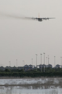 Joint Base Charleston – Weapons Station, S.C. – A specially-modified Air Force Reserve C-130 Hercules tactical cargo aircraft, assigned to the 910th Airlift Wing, based at Youngstown Air Reserve Station, Ohio, disperses a water-diluted EPA-approved insecticide over an area known as the spoils site here, June 15, 2013. The 30-acre ‘spoils site’ is known to produce approximately 40-million mosquitoes per acre, or 1.2 billion of the pest insects, annually. The 910th’s Aerial Spray Unit conducted spraying operations here, June 15, 2013 to control the population of the disease-carrying pest insects at the installation. The 910th sprayed approximately 16,500 acres to provide much sought relief for the base’s populace. The 910th’s 757th Airlift Squadron is home to the Department of Defense’s only large-area, fixed-wing aerial spray capability. U.S. Air Force photo by Tech. Sgt. Rick Lisum.