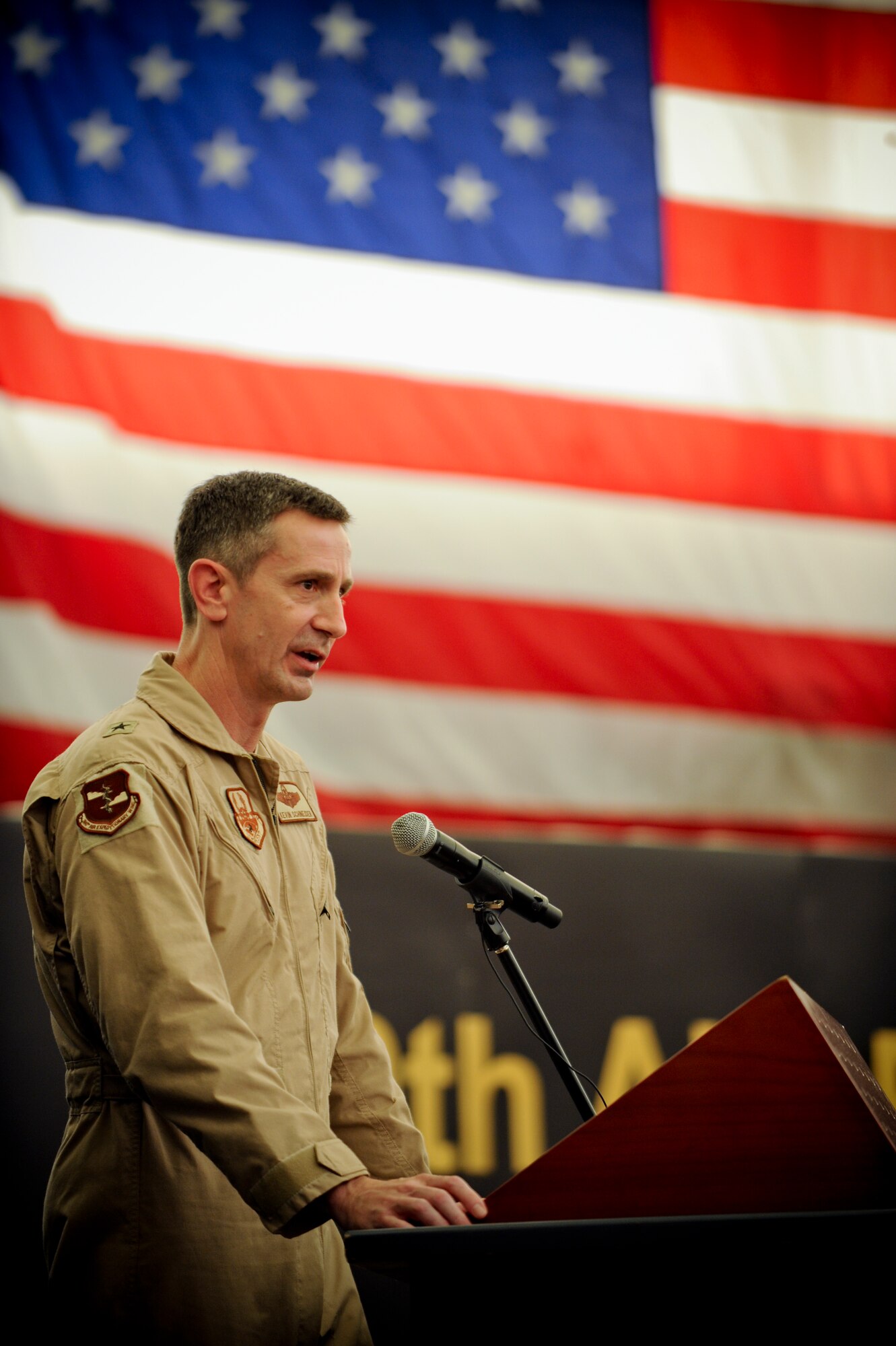U.S. Air Force Brig. Gen. Kevin B. Schneider, 380th Air Expeditionary Wing commander, speaks to members of the 380th AEW during the wing's change of command ceremony at an undisclosed location in Southwest Asia June 20. Schneider
took command from Brig. Gen. Paul McGillicuddy. Lt. Gen. David L. Goldfein, U.S. Air Forces Central commander, presided over the ceremony. (U.S. Air Force photo by Staff Sgt. Joshua J. Garcia)
