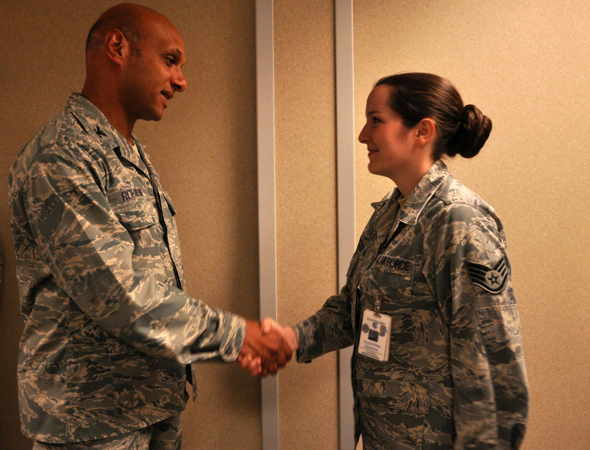 Col. Brian Robinson, 19th Airlift Wing commander, coins Staff Sgt. Amanda Tokarczk, 19th Medical Operations Squadron Family Health team lead, for being selected as Combat Airlifter of the Week June 17, 2013, at Little Rock Air Force Base, Ark. Tokarczyk increased colonoscopy screenings by 21 percent, exceeding the Air Force goal by 12 percent and was hand selected by the 19th MDOS commander as the colonoscopy metrics champion. (U.S. Air Force photo by Senior Airman Regina Agoha)