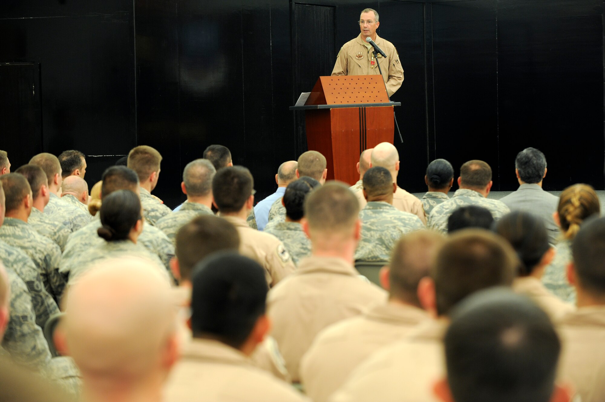 U.S. Air Force Brig. Gen. Paul McGillicuddy, former 380th Air Expeditionary Wing commander, speaks to Airmen of the 380th AEW during the wing change of command ceremony at an undisclosed location in Southwest Asia June 20, 2013.  McGillicuddy thanked the Airmen for their hard work during his tenure as the wing commander. (U.S. Air Force photo by Staff Sgt. Joshua J. Garcia)

