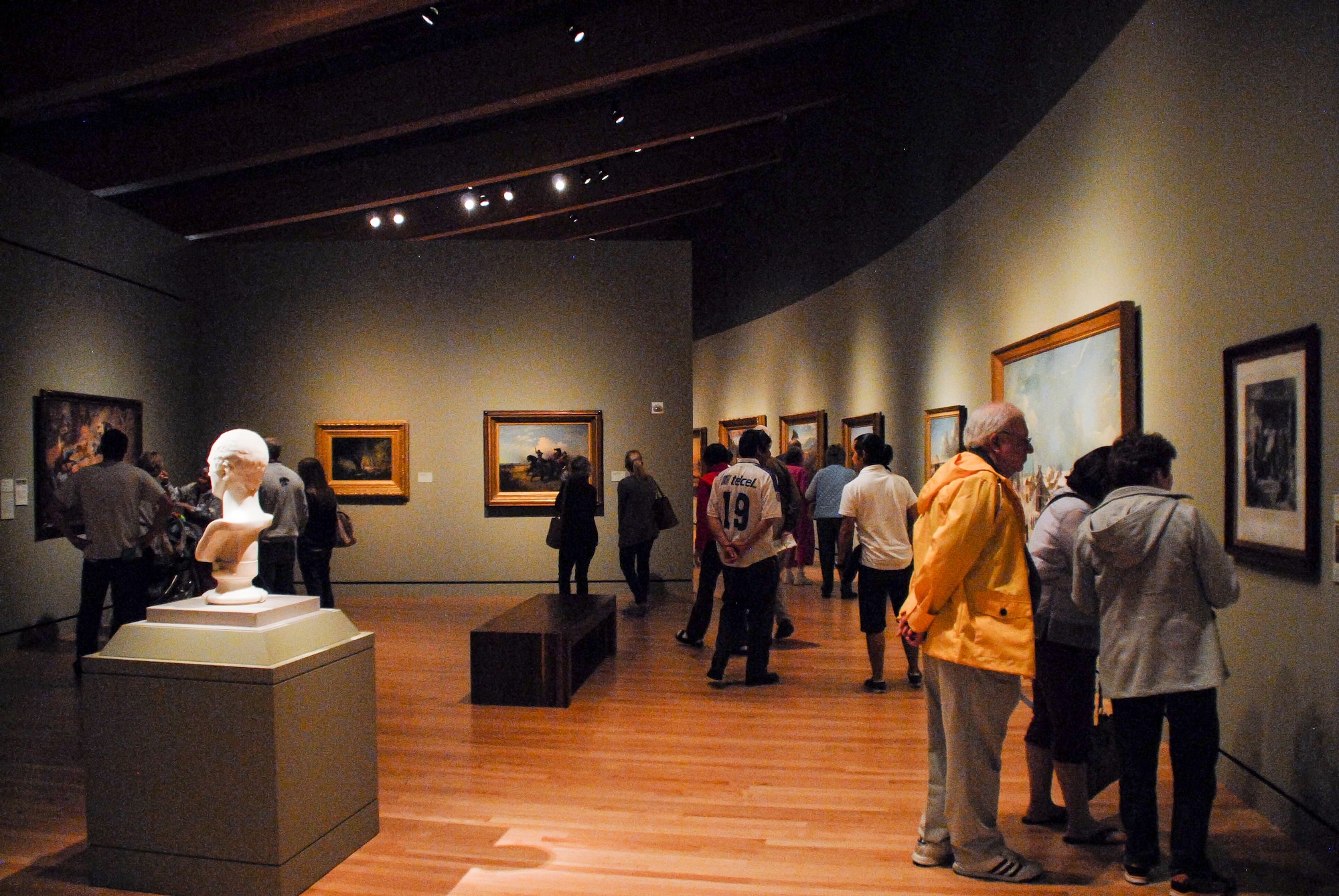 People peruse the works in the Crystal Bridges Museum of American Arts May 12, 2013, in Bentonville, Ark. The museum grants free admission to their permanent collection of more than 400 works of American art. (U.S. Air Force photo by Staff Sgt. Jake Barreiro)