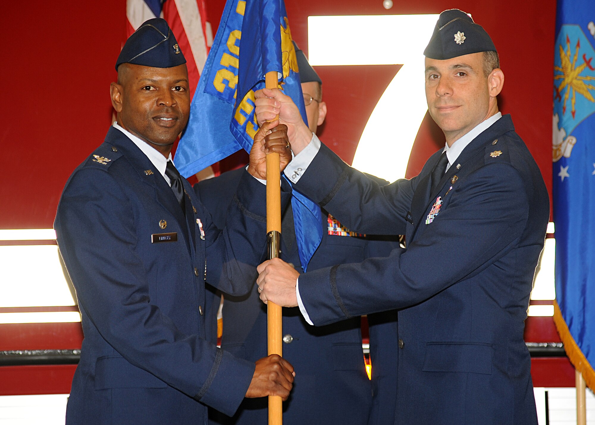 (Left) Col. Joe Lindsey, 319th Mission Support Group commander, hands the 319th Civil Engineer Squadron guidon to Lt. Col. Edward Phillips during a change-of-command ceremony June 17, 2013, at Grand Forks Air Force Base, N.D. Phillips replaced Lt. Col. Sara Deaver. (U.S. Air Force photo/ Airman 1st Class Xavier Navarro)