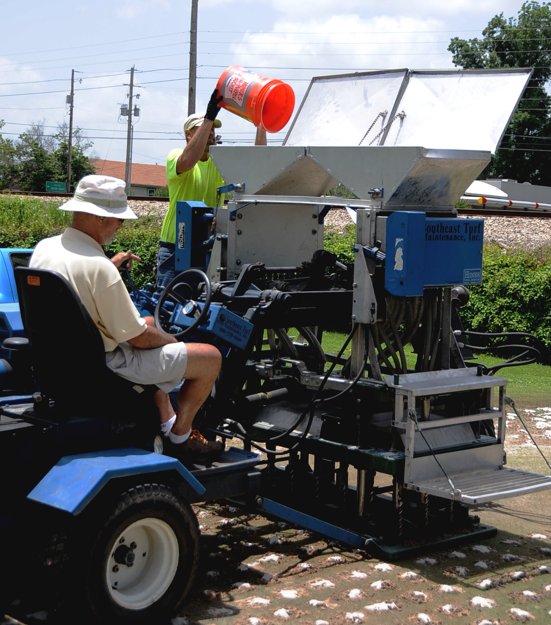 David Nusbaum, Fox Run Golf Course maintenance supervisor, loads dry sand into a deep drill and aeration machine on Barksdale Air Force Base, La., June 12, 2013. The Fox Run Golf Course used more than 27 tons of dry sand to fill aeration holes on putting greens. (U.S. Air Force photo/Staff Sgt. Jason McCasland)