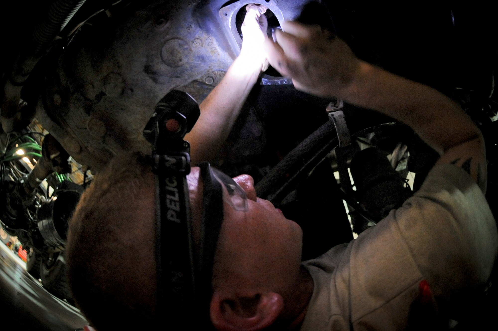 U.S. Air Force Airman 1st Class Jason Brown, 380th Expeditionary Logistics Squadron vehicle mechanic, makes adjustments to a clutch on a vehicle at an undisclosed location in Southwest Asia June 19, 2013. The vehicle maintenance shop maintains all government owned vehicles for the installation. Brown hails from Akron, Ohio, and is deployed from Royal Air Force Mildenhall, England. (U.S. Air Force photo by Staff Sgt. Joshua J. Garcia)
