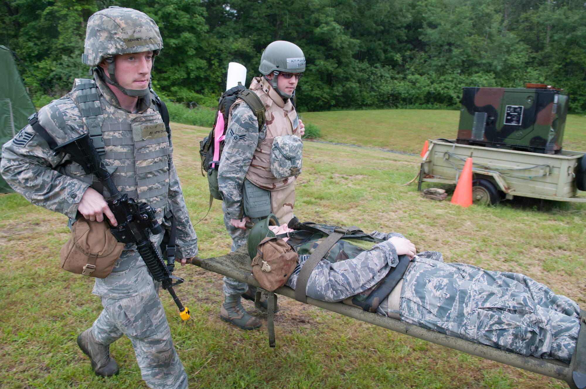 HANSCOM AIR FORCE BASE, Mass. – Tech. Sgt. Kenneth Osborne and Airman 1st  Class Vincent Myers performs a litter carry as part of a Self-Aid and Buddy Care scenario as part of the Consolidated Unit Inspection at Camp Patriot June 7. The CUI inspection team tested base readiness, compliance and a Logistics Compliance Assessment Program review as well as a thorough Article Six inspection, which examined the 66th Air Base Group’s Judge Advocate Office’s ability to provide comprehensive legal services. Inspectors also looked at several specific focus areas. (U.S. Air Force photo by Rick Berry)