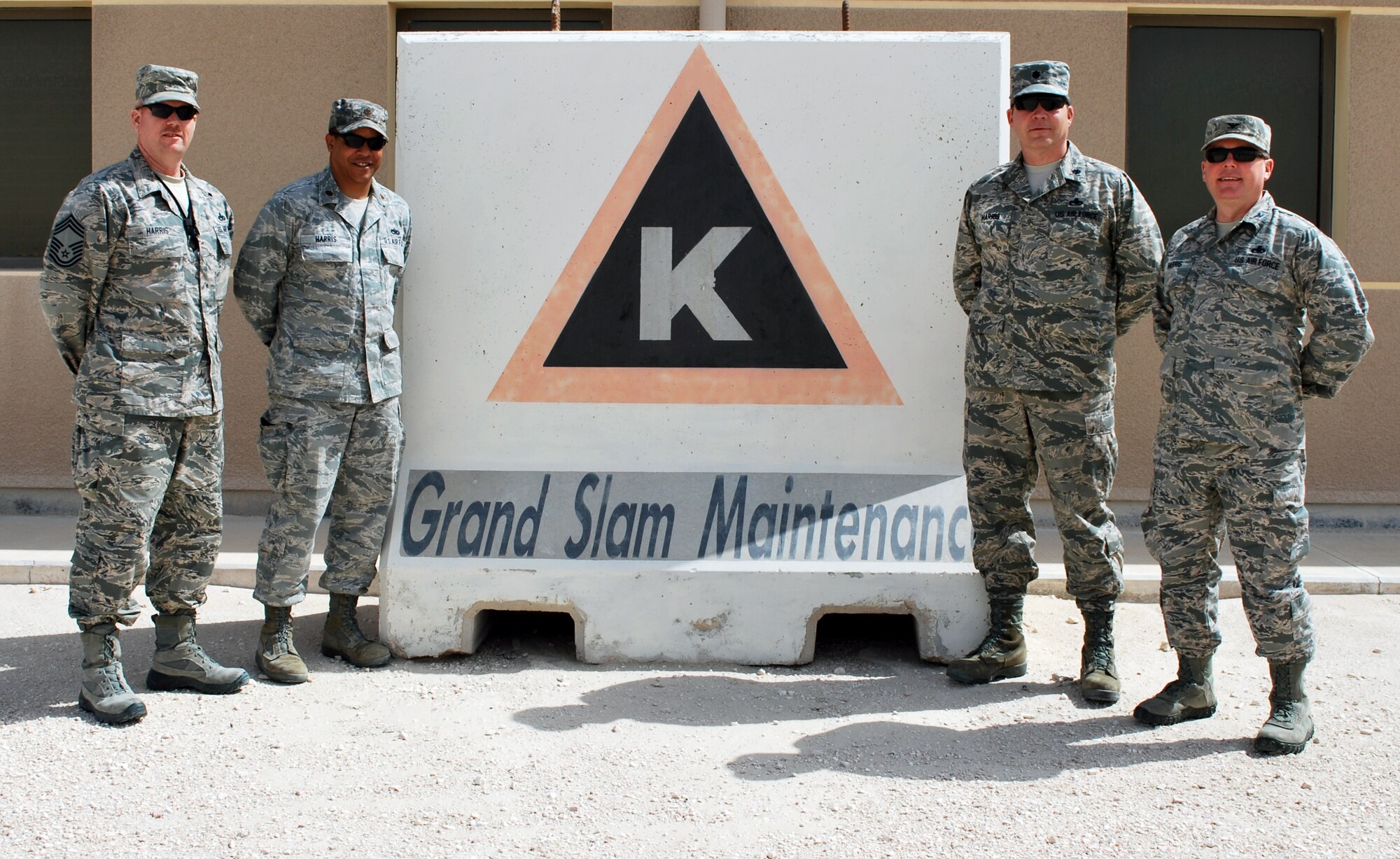 From left to right: Chief Master Sgt. Daryl P. Harris, Maj. Fencisco N. Harris, Lt. Col. Mark E. Harris and Col. Bryan L. Harris pose with their “Grand Slam Maintenance” barrier art showcasing the fact they all have the same last name at the 379th Air Expeditionary Wing in Southwest Asia, June 19, 2013. Chief Harris is the 379th Expeditionary Maintenance Squadron superintendent hailing from Freeport, Ill. Major Harris is the 379th Expeditionary Maintenance Operations Squadron commander from Valley Center, Calif. Colonel Mark Harris is the 379th Expeditionary Maintenance Group deputy commander from Hickory, N.C., and Colonel Bryan Harris is the 379th EMXG commander from Marshall, Texas. (U.S. Air Force photo)