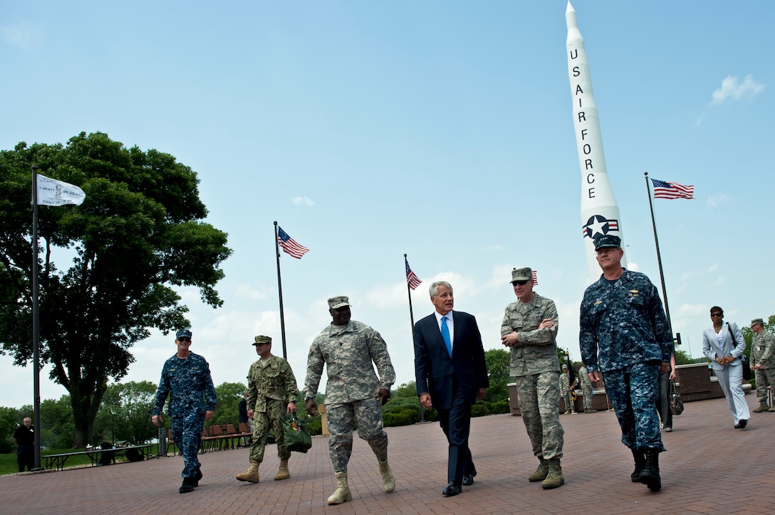 Defense Secretary Chuck Hagel walks with Air Force Gen. C. Robert "Bob" Kehler, second from right, commander of U.S. Strategic Command, Navy Vice Adm. Tim Giardina, the command's deputy commander, and Army Command Sgt. Maj. Patrick Z. Alston, the command's senior enlisted leader, on Offutt Air Force Base, Neb., June 20, 2013. Hagel met with senior leaders, received command briefings, and visited with troops and civilians to thank them for their service. DOD photo by Erin A. Kirk-Cuomo