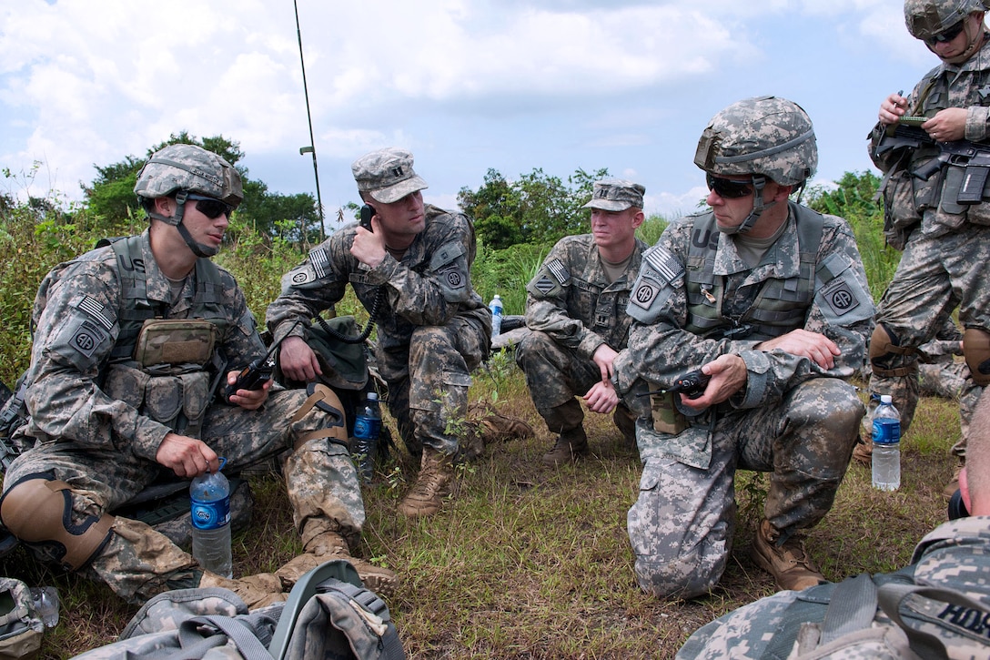 U.S. Army Lt. Col. Christopher Hockenberry, right kneeling, gives ...