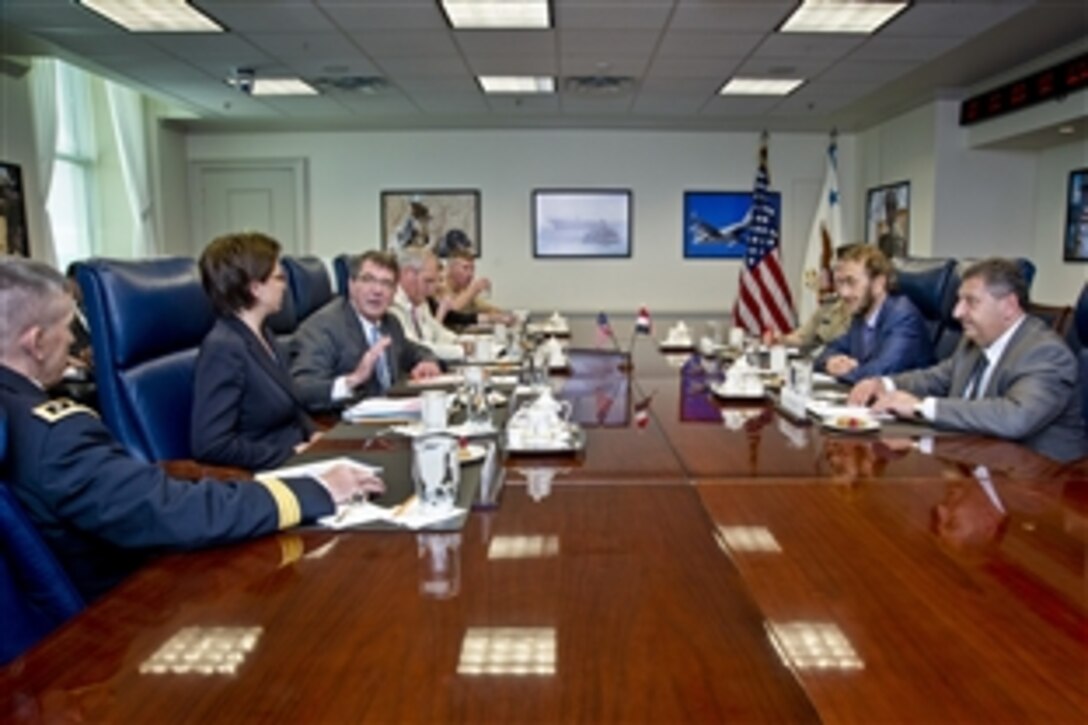 U.S. Deputy Defense Secretary Ash Carter meets with acting Iraqi Defense Minister Sadun Farhan al-Dulaimi at the Pentagon, June 19, 2013. The two defense leaders discussed issues of mutual interest.