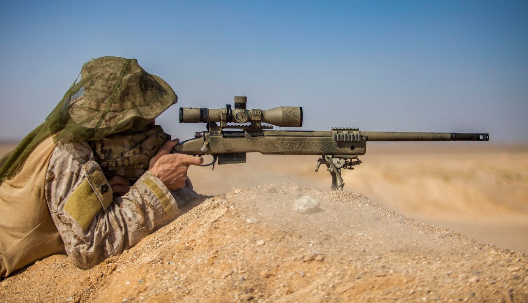A 26th Marine Expeditionary Unit (MEU) Maritime Raid Force Marine engages a long distance target with an M40A5 sniper rifle at a range in Jordan, June 10, 2013. Exercise Eager Lion 2013 is an annual, multinational exercise designed to strengthen military-to-military relationships and enhance security and stability in the region by responding to modern-day security scenarios. The 26th MEU is a Marine Air-Ground Task Force forward-deployed to the U.S. 5th Fleet area of responsibility aboard the Kearsarge Amphibious Ready Group serving as a sea-based, expeditionary crisis response force capable of conducting amphibious operations across the full range of military operations. (U.S. Marine Corps photograph by Sgt. Christopher Q. Stone, 26th MEU Combat Camera/Released)
