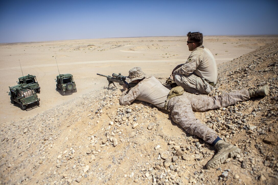 A 26th Marine Expeditionary Unit (MEU) Maritime Raid Force Marine engages a long distance target with an M40A5 sniper rifle at a range in Jordan, June 10, 2013. Exercise Eager Lion 2013 is an annual, multinational exercise designed to strengthen military-to-military relationships and enhance security and stability in the region by responding to realistic, modern-day security scenarios. The 26th MEU is a Marine Air-Ground Task Force forward-deployed to the U.S. 5th Fleet area of responsibility aboard the Kearsarge Amphibious Ready Group serving as a sea-based, expeditionary crisis response force capable of conducting amphibious operations across the full range of military operations. (U.S. Marine Corps photograph by Sgt. Christopher Q. Stone, 26th MEU Combat Camera/Not Released)