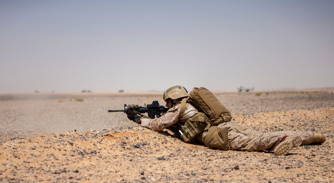 A 26th Marine Expeditionary Unit (MEU) Maritime Raid Force Marine lies in the prone as he engages simulated hostile targets during an immediate action drill exercise at a range in Jordan, June 13, 2013. Exercise Eager Lion 2013 is an annual, multinational exercise designed to strengthen military-to-military relationships and enhance security and stability in the region by responding to modern-day security scenarios. The 26th MEU is a Marine Air-Ground Task Force forward-deployed to the U.S. 5th Fleet area of responsibility aboard the Kearsarge Amphibious Ready Group serving as a sea-based, expeditionary crisis response force capable of conducting amphibious operations across the full range of military operations. (U.S. Marine Corps photograph by Sgt. Christopher Q. Stone, 26th MEU Combat Camera/Released)