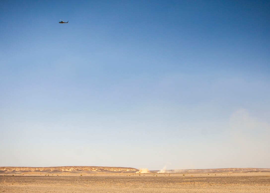 An AH-1W Super Cobra assigned to Marine Medium Tiltrotor Squadron (VMM) 266 (Reinforced), 26th Marine Expeditionary Unit (MEU), engages simulated hostile targets providing close air support for the MEU's Maritime Raid Force Marines during immediate action drill exercise at a range in Jordan, June 13, 2013. Exercise Eager Lion 2013 is an annual, multinational exercise designed to strengthen military-to-military relationships and enhance security and stability in the region by responding to modern-day security scenarios. The 26th MEU is a Marine Air-Ground Task Force forward-deployed to the U.S. 5th Fleet area of responsibility aboard the Kearsarge Amphibious Ready Group serving as a sea-based, expeditionary crisis response force capable of conducting amphibious operations across the full range of military operations. (U.S. Marine Corps photograph by Sgt. Christopher Q. Stone, 26th MEU Combat Camera/Released)