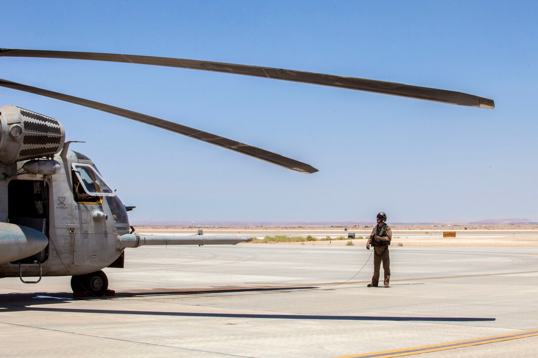 U.S. Marine Cpl. Matthew Cox, a CH-53E Super Stallion crew chief assigned to Marine Medium Tiltrotor Squadron (VMM) 266 (Reinforced), 26th Marine Expeditionary Unit (MEU), preforms pre-flight inspections on his aircraft at King Faisal Air Base in Jordan, June 14, 2013. Exercise Eager Lion 2013 is an annual, multinational exercise designed to strengthen military-to-military relationships and enhance security and stability in the region by responding to modern-day security scenarios. The 26th MEU is a Marine Air-Ground Task Force forward-deployed to the U.S. 5th Fleet area of responsibility aboard the Kearsarge Amphibious Ready Group serving as a sea-based, expeditionary crisis response force capable of conducting amphibious operations across the full range of military operations. (U.S. Marine Corps photograph by Sgt. Christopher Q. Stone, 26th MEU Combat Camera/Released)