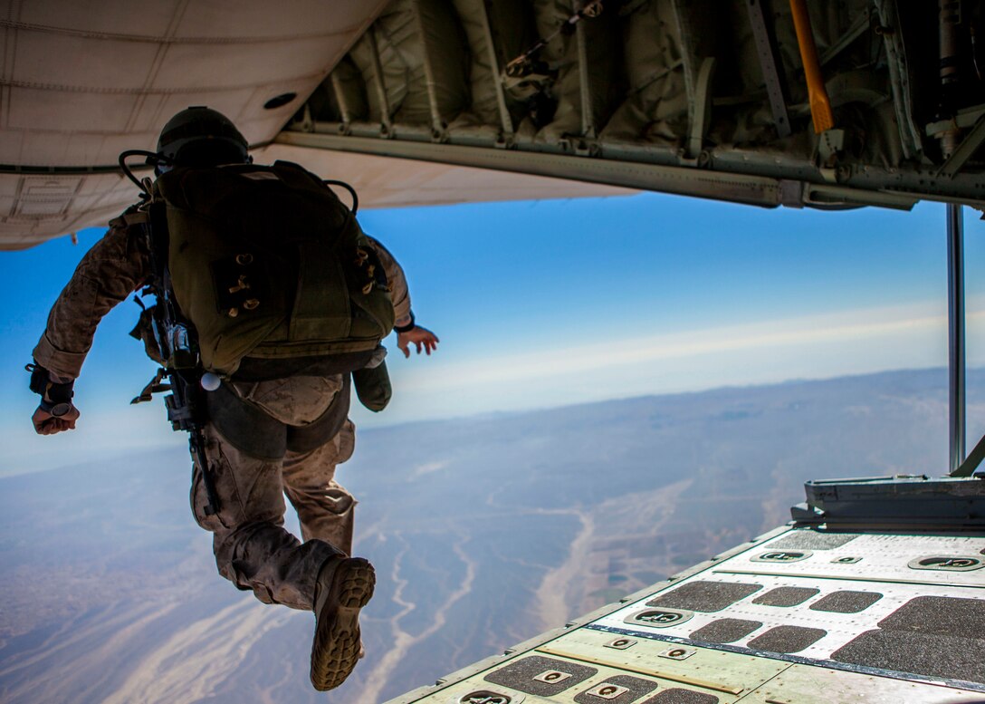 A 26th Marine Expeditionary Unit (MEU) Maritime Raid Force Marine exits a KC-130J Hercules assigned to 26th MEU command element, during high altitude, high opening parachute operations over King Faisal Air Base in Jordan, June 15, 2013. Exercise Eager Lion 2013 is an annual, multinational exercise designed to strengthen military-to-military relationships and enhance security and stability in the region by responding to realistic, modern-day security scenarios. The 26th MEU is a Marine Air-Ground Task Force forward-deployed to the U.S. 5th Fleet area of responsibility aboard the Kearsarge Amphibious Ready Group serving as a sea-based, expeditionary crisis response force capable of conducting amphibious operations across the full range of military operations. (U.S. Marine Corps photo by Sgt. Christopher Q. Stone, 26th MEU Combat Camera/Released)