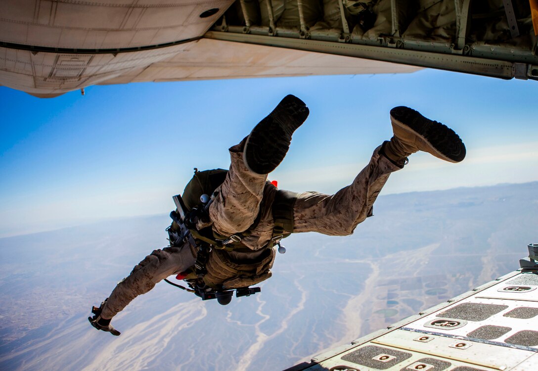 A 26th Marine Expeditionary Unit (MEU) Maritime Raid Force Marine exits a KC-130J Hercules assigned to 26th MEU command element, during high altitude, high opening parachute operations over King Faisal Air Base in Jordan, June 15, 2013. Exercise Eager Lion 2013 is an annual, multinational exercise designed to strengthen military-to-military relationships and enhance security and stability in the region by responding to realistic, modern-day security scenarios. The 26th MEU is a Marine Air-Ground Task Force forward-deployed to the U.S. 5th Fleet area of responsibility aboard the Kearsarge Amphibious Ready Group serving as a sea-based, expeditionary crisis response force capable of conducting amphibious operations across the full range of military operations. (U.S. Marine Corps photo by Sgt. Christopher Q. Stone, 26th MEU Combat Camera/Released)