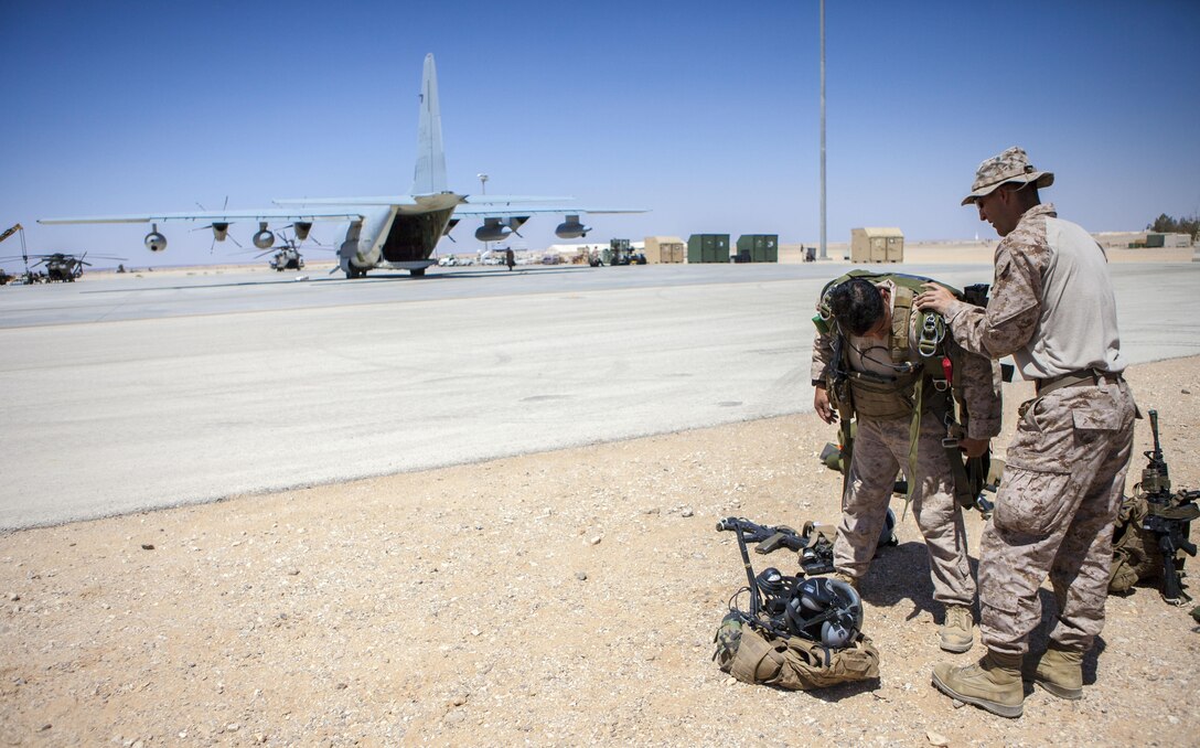 A 26th Marine Expeditionary Unit (MEU) Maritime Raid Force Marine dons his parachute to conduct high altitude, high opening parachute operations from a KC-130J Hercules assigned to 26th MEU command element, over King Faisal Air Base in Jordan, June 15, 2013. Exercise Eager Lion 2013 is an annual, multinational exercise designed to strengthen military-to-military relationships and enhance security and stability in the region by responding to realistic, modern-day security scenarios. The 26th MEU is a Marine Air-Ground Task Force forward-deployed to the U.S. 5th Fleet area of responsibility aboard the Kearsarge Amphibious Ready Group serving as a sea-based, expeditionary crisis response force capable of conducting amphibious operations across the full range of military operations. (U.S. Marine Corps photo by Sgt. Christopher Q. Stone, 26th MEU Combat Camera/Released)