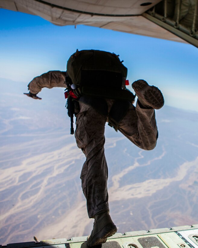 A 26th Marine Expeditionary Unit (MEU) Maritime Raid Force Marine exits a KC-130J Hercules assigned to 26th MEU command element, during high altitude, high opening parachute operations over King Faisal Air Base in Jordan, June 15, 2013. Exercise Eager Lion 2013 is an annual, multinational exercise designed to strengthen military-to-military relationships and enhance security and stability in the region by responding to realistic, modern-day security scenarios. The 26th MEU is a Marine Air-Ground Task Force forward-deployed to the U.S. 5th Fleet area of responsibility aboard the Kearsarge Amphibious Ready Group serving as a sea-based, expeditionary crisis response force capable of conducting amphibious operations across the full range of military operations. (U.S. Marine Corps photo by Sgt. Christopher Q. Stone, 26th MEU Combat Camera/Released)
