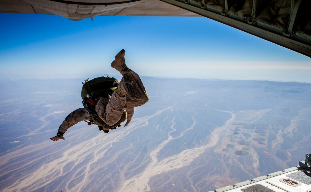 A 26th Marine Expeditionary Unit (MEU) Maritime Raid Force Marine exits a KC-130J Hercules assigned to 26th MEU command element, during high altitude, high opening parachute operations over King Faisal Air Base in Jordan, June 15, 2013. Exercise Eager Lion 2013 is an annual, multinational exercise designed to strengthen military-to-military relationships and enhance security and stability in the region by responding to realistic, modern-day security scenarios. This is a recurring exercise. The 26th MEU is a Marine Air-Ground Task Force forward-deployed to the U.S. 5th Fleet area of responsibility aboard the Kearsarge Amphibious Ready Group serving as a sea-based, expeditionary crisis response force capable of conducting amphibious operations across the full range of military operations. (U.S. Marine Corps photo by Sgt. Christopher Q. Stone, 26th MEU Combat Camera/Released)