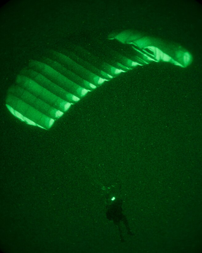 A 26th Marine Expeditionary Unit (MEU) Maritime Raid Force Marine descends to the ground while conducting parachute operations over King Faisal Air Base in Jordan, June 18, 2013. Exercise Eager Lion 2013 is an annual, multinational exercise designed to strengthen military-to-military relationships and enhance security and stability in the region by responding to realistic, modern-day security scenarios. The 26th MEU is a Marine Air-Ground Task Force forward-deployed to the U.S. 5th Fleet area of responsibility aboard the Kearsarge Amphibious Ready Group serving as a sea-based, expeditionary crisis response force capable of conducting amphibious operations across the full range of military operations. (U.S. Marine Corps photo by Sgt. Christopher Q. Stone, 26th MEU Combat Camera/Released)