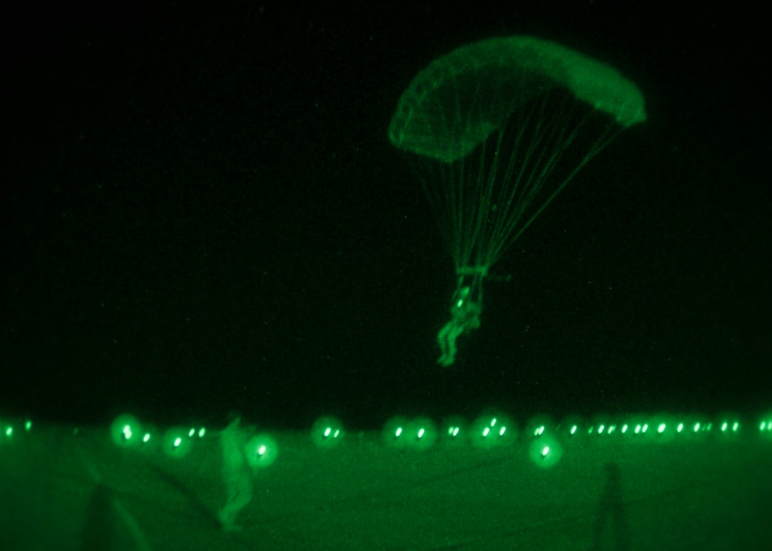 A 26th Marine Expeditionary Unit (MEU) Maritime Raid Force Marine descends to the ground while conducting parachute operations over King Faisal Air Base in Jordan, June 18, 2013. Exercise Eager Lion 2013 is an annual, multinational exercise designed to strengthen military-to-military relationships and enhance security and stability in the region by responding to realistic, modern-day security scenarios. The 26th MEU is a Marine Air-Ground Task Force forward-deployed to the U.S. 5th Fleet area of responsibility aboard the Kearsarge Amphibious Ready Group serving as a sea-based, expeditionary crisis response force capable of conducting amphibious operations across the full range of military operations. (U.S. Marine Corps photo by Sgt. Christopher Q. Stone, 26th MEU Combat Camera/Released)