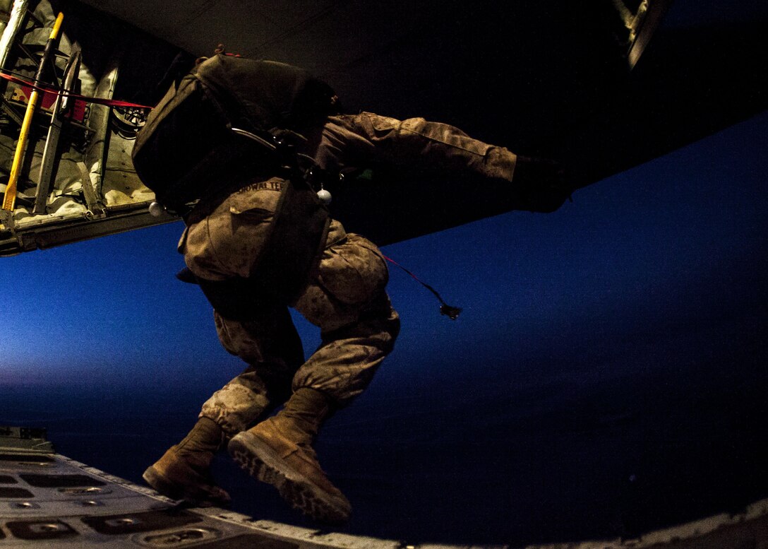 A 26th Marine Expeditionary Unit (MEU) Maritime Raid Force Marine exits a C-130J Hercules assigned to 26th MEU command element, during parachute operations over King Faisal Air Base in Jordan, June 20, 2013. Exercise Eager Lion 2013 is an annual, multinational exercise designed to strengthen military-to-military relationships and enhance security and stability in the region by responding to modern-day security scenarios. The 26th MEU is a Marine Air-Ground Task Force forward-deployed to the U.S. 5th Fleet area of responsibility aboard the Kearsarge Amphibious Ready Group serving as a sea-based, expeditionary crisis response force capable of conducting amphibious operations across the full range of military operations. (U.S. Marine Corps photograph by Sgt. Christopher Q. Stone, 26th MEU Combat Camera/Released)