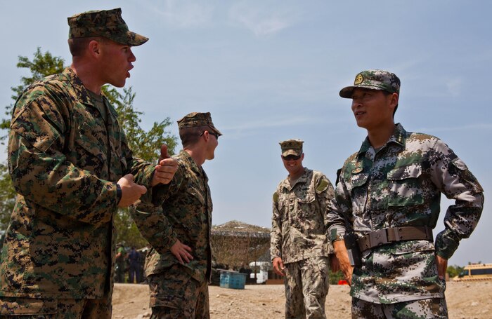 U.S. Marine Sgt. Robert W. Walker, left, explains the capabilities of the miniature deployable assistance water purification system to People’s Liberation Army Capt. Wang Weijin at a disaster site in Biang, Brunei Darussalam, June 19 as part of the Association of Southeast Asian Nations Humanitarian Assistance/Disaster Relief and Military Medicine Exercise (AHMX). Engineers with China, Singapore and the U.S. demonstrated their water purification capabilities to senior leaders at the disaster site. Walker is a engineer equipment electrical systems technician with 9th Engineer Support Battalion, 3rd Marine Logistics Group, III Marine Expeditionary Force. Weijin is a Chinese engineer.


