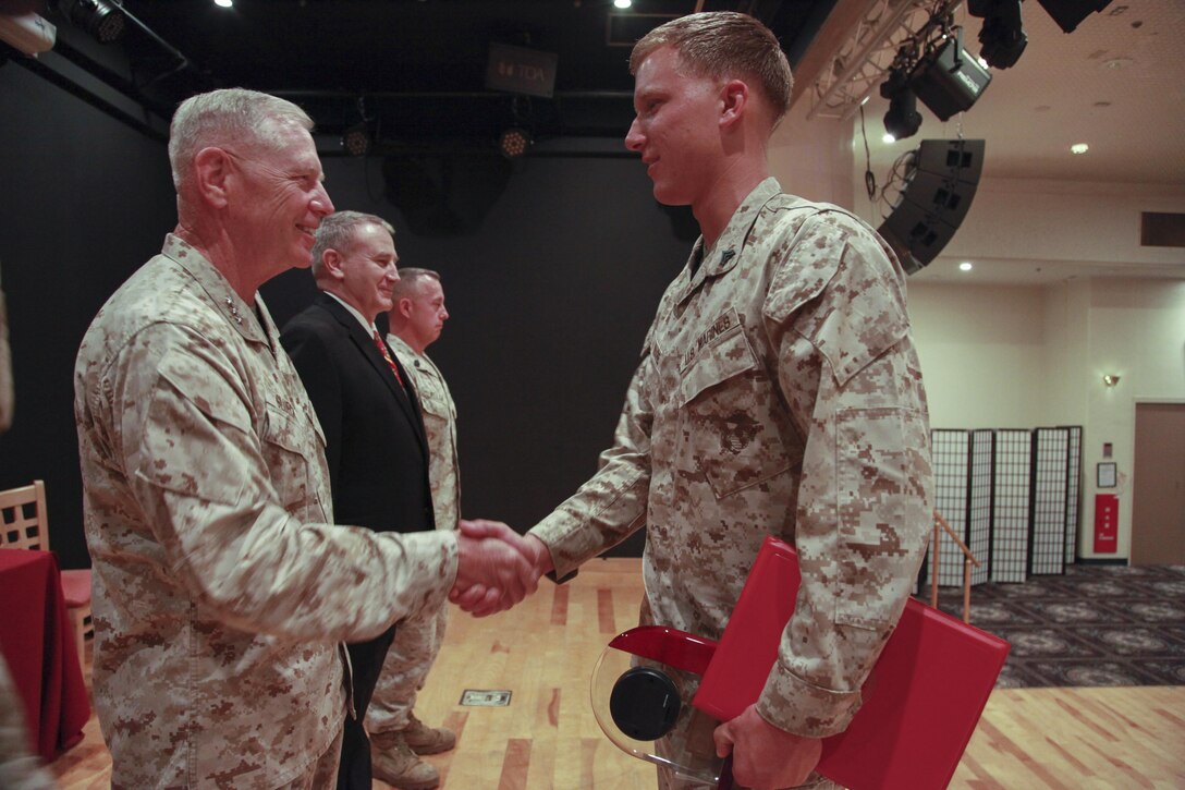Lt. Gen. Kenneth J. Glueck Jr. presents Cpl. Lane T. Ware with the Motor Transport Operator of the Year award June 12 during the 3rd annual U.S. Marine Corps Motor Transport Association Inc. 2012 awards on Camp Kinser. Ware earned the award for consistently performing his duties in an exemplary and highly professional manner, according to the citation. Ware is a motor transport operator with 9th Engineer Support Battalion, 3rd Marine Logistics Group, III MEF. 