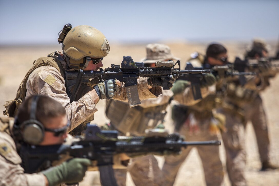 26th Marine Expeditionary Unit (MEU) Maritime Raid Force Marines fire M4 Carbines at a range in Jordan, June 19, 2013. Exercise Eager Lion 2013 is an annual, multinational exercise designed to strengthen military-to-military relationships and enhance security and stability in the region by responding to modern-day security scenarios. The 26th MEU is a Marine Air-Ground Task Force forward-deployed to the U.S. 5th Fleet area of responsibility aboard the Kearsarge Amphibious Ready Group serving as a sea-based, expeditionary crisis response force capable of conducting amphibious operations across the full range of military operations. (U.S. Marine Corps photograph by Sgt. Christopher Q. Stone, 26th MEU Combat Camera/Released)