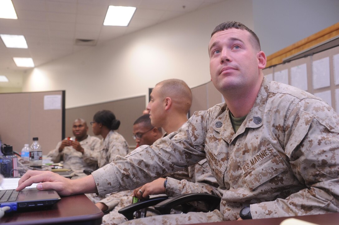 Marines work at a Command Operations Center during a logistics war game aboard Marine Corps Base Quantico on June 19, 2013. Over 30 organizations participated in the week long war game.
