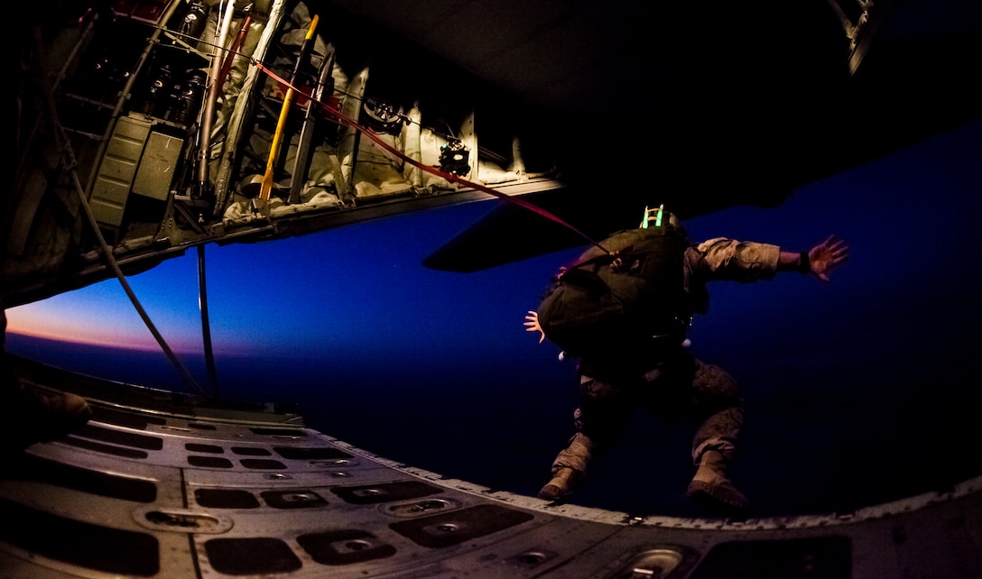 A 26th Marine Expeditionary Unit (MEU) Maritime Raid Force Marine exits a C-130J Hercules assigned to 26th MEU command element, during parachute operations over King Faisal Air Base in Jordan, June 20, 2013. Exercise Eager Lion 2013 is an annual, multinational exercise designed to strengthen military-to-military relationships and enhance security and stability in the region by responding to modern-day security scenarios. The 26th MEU is a Marine Air-Ground Task Force forward-deployed to the U.S. 5th Fleet area of responsibility aboard the Kearsarge Amphibious Ready Group serving as a sea-based, expeditionary crisis response force capable of conducting amphibious operations across the full range of military operations. (U.S. Marine Corps photograph by Sgt. Christopher Q. Stone, 26th MEU Combat Camera/Released)