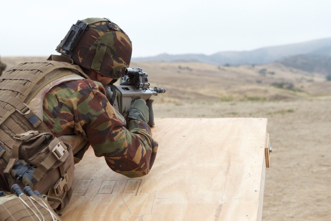 Private Waake Tua, a New Zealand Army soldier serving with 2nd, 1st Battalion, lays in the prone position behind a barricade while engaging targets at Range 218 here during Dawn Blitz 2013, June 14. The New Zealanders moved from barricade to barricade while engaging targets and conducting tactical reloads to simulate shooting in an urban environment. Dawn Blitz 2013 is a scenario-driven exercise designed to test Navy and Marine Corps forces at the Marine Expeditionary Brigade (MEB) and Expeditionary Strike Group (ESG) level, while promoting military-to-military cooperation and interoperability with partnered nations.