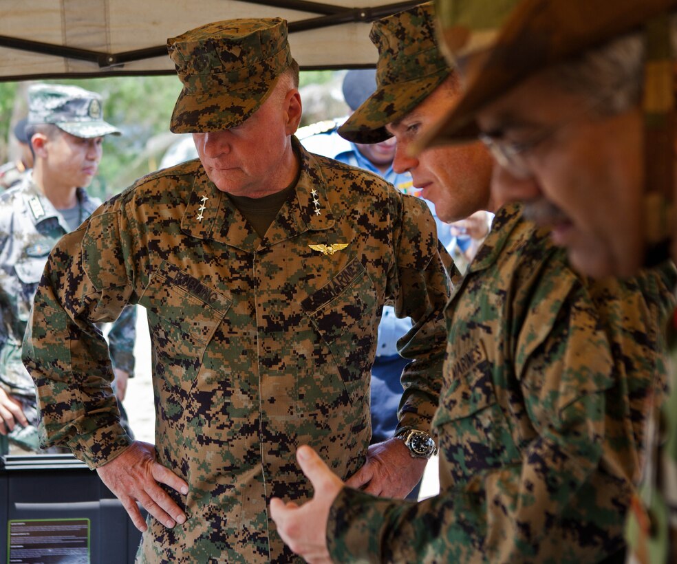 U.S. Marine Sgt. Robert W. Walker, center, explains the capabilities of the miniature deployable assistance water purification system to U.S. Marine Lt. Gen. Terry G. Robling at a disaster site in Biang, Brunei Darussalam, June 19 as part of the Association of Southeast Asian Nations Humanitarian Assistance/Disaster Relief and Military Medicine Exercise (AHMX). The disaster site is the location of the field training exercise portion of the multilateral exercise, which provides a platform for regional partner nations to address shared security challenges, strengthen defense cooperation, enhance interoperability and promote stability in the region. Robling is the commanding general of U.S. Marine Corps Forces, Pacific. Walker is an engineer equipment electrical systems technician with 9th Engineer Support Battalion, 3rd Marine Logistics Group, III Marine Expeditionary Force.