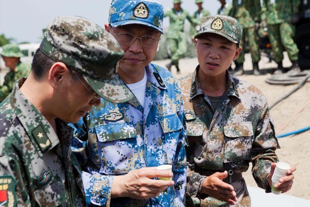 People's Liberation Army Navy Rear Adm. Kan Li Kui drinks a sample of purified water at a disaster site in Biang, Brunei Darussalam June 19, as part of the Association of Southeast Asian Nations Humanitarian Assistance/Disaster Relief and Military Medicine Exercise (AHMX). Engineers with China, Singapore and the U.S. demonstrated their water purification capabilities to senior leaders at the disaster site. Kui is the Deputy Chief of the Operations Department, General Staff Department.