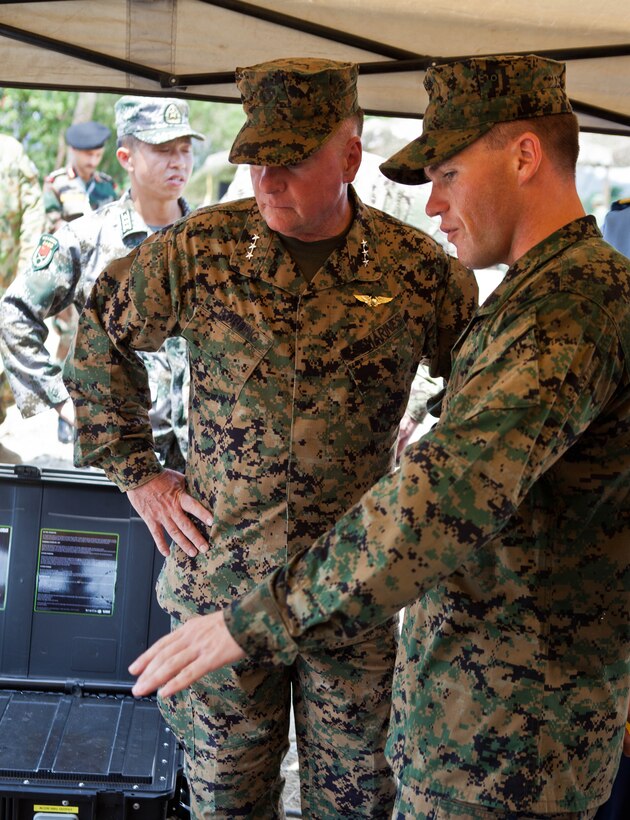 U.S. Marine Sgt. Robert W. Walker, right, explains the capabilities of the miniature deployable assistance water purification system to U.S. Marine Lt. Gen. Terry G. Robling at a disaster site in Biang, Brunei Darussalam, June 19 as part of the Association of Southeast Asian Nations Humanitarian Assistance/Disaster Relief and Military Medicine Exercise (AHMX). The disaster site is the location of the field training exercise portion of the multilateral exercise, which provides a platform for regional partner nations to address shared security challenges, strengthen defense cooperation, enhance interoperability and promote stability in the region. Robling is the commanding general of U.S. Marine Corps Forces, Pacific.  Walker is an engineer equipment electrical systems technician with 9th Engineer Support Battalion, 3rd Marine Logistics Group, III Marine Expeditionary Force.