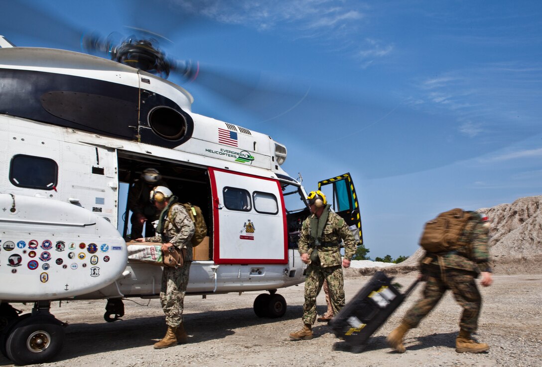 U.S. Marine and Navy engineers exit a Puma helicopter at a simulated disaster site in Biang, Brunei Darussalam, June 19 during the Association of Southeast Asian Nations Humanitarian Assistance/Disaster Relief and Military Medicine Exercise (AHMX). The multilateral exercise provides a platform for regional partner nations to address shared security challenges, strengthen defense cooperation, enhance interoperability and promote stability in the region.